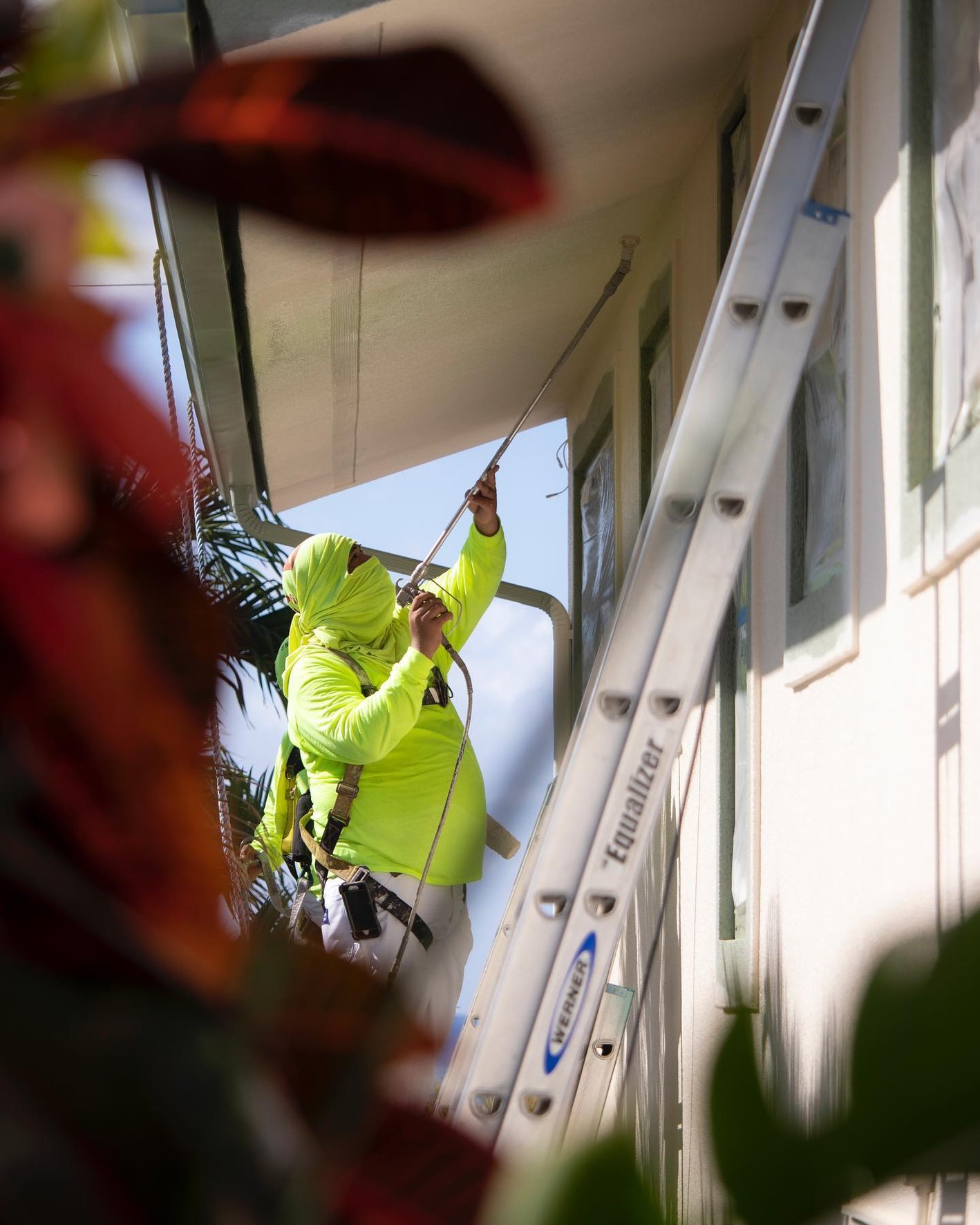 Professional painter painting home exterior in Ewa Beach