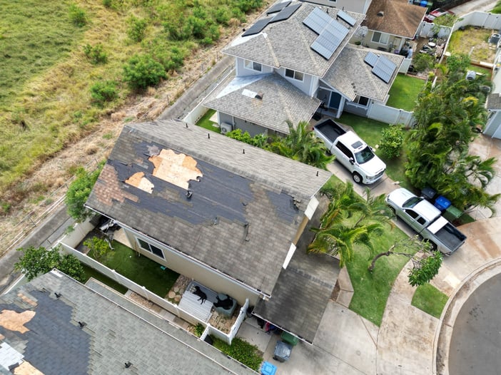 Aerial view of extensive shingle and roof damage after Hurricane Lala on Oahu